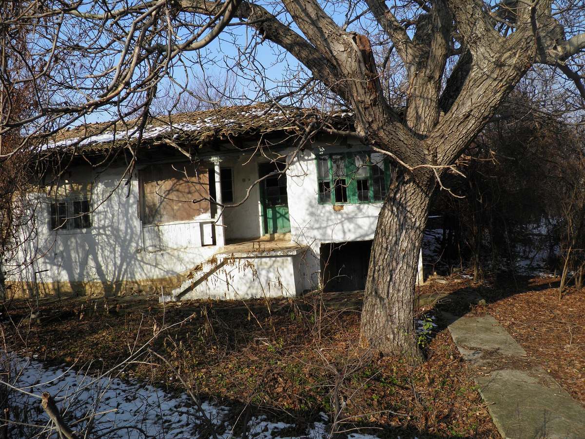 A traditional Bulgarian village house in stone and wood, the kind of property where the standard home insurance policy usually fails British buyers